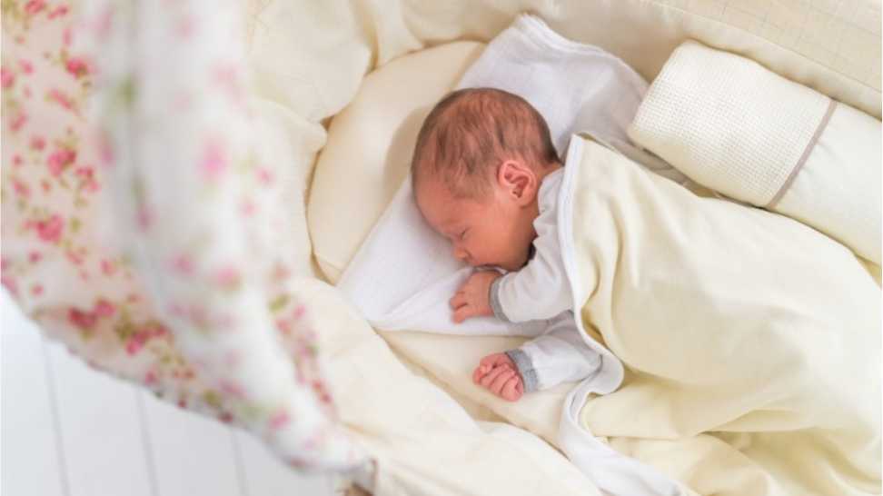 cute little baby lying in cradle