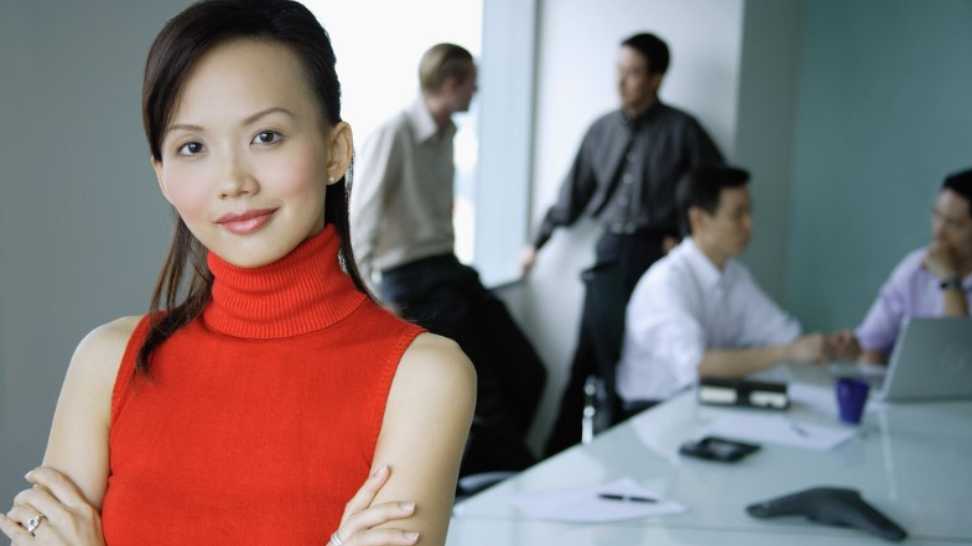 female executive wearing a sleeveless turtleneck sweater